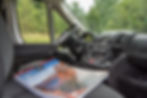 Atlas sitting on the front seat of campervan