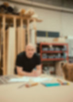 Photo of Paul Domish leaning on a bench at drifter vans hq