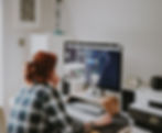 Photo of a woman preparing to start work at her desk, with a focused and organized workspace.