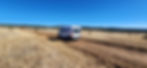 Susan’s van driving down a quiet, remote road surrounded by open landscape, capturing the spirit of solo travel and freedom.